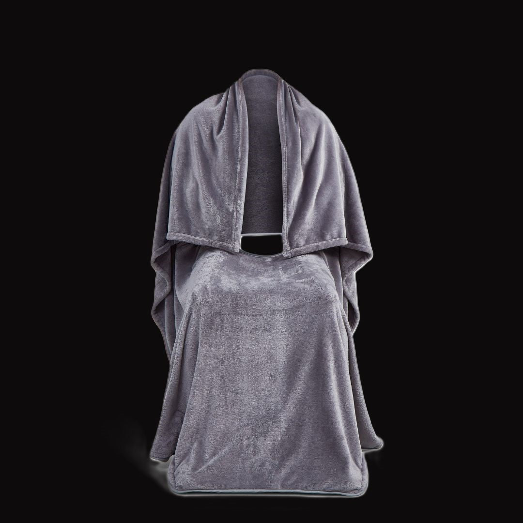 Front view of the Snhug Sit sitting blanket draped over a chair, showing the center opening and full-length coverage designed for seated warmth and comfort.