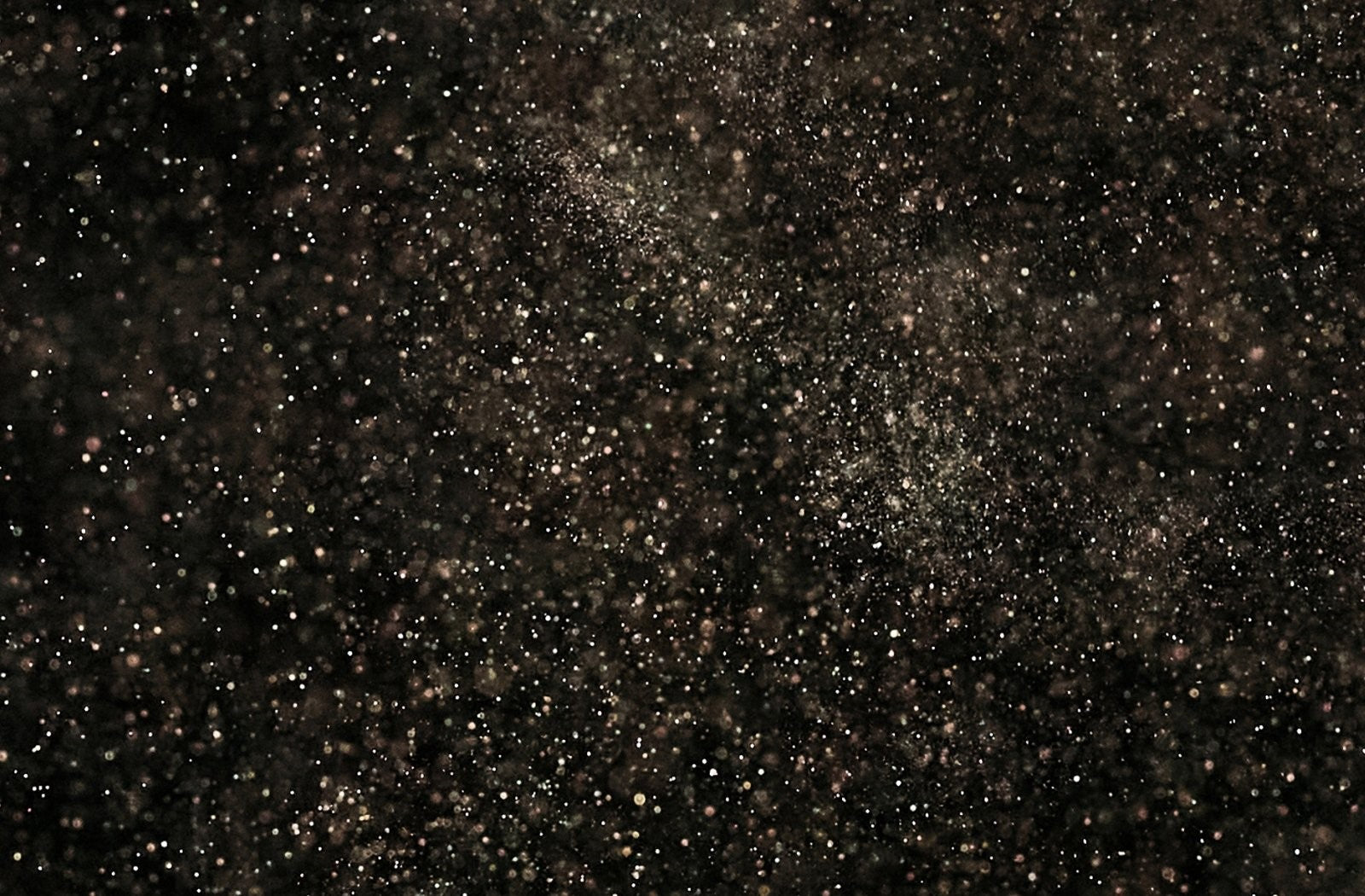 Dark textured background with soft scattered light particles, creating a subtle starry night or glitter effect behind a Trustpilot reviews section.