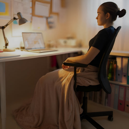 Snhug Sit sitting blanket worn around the waist with no sleeves, keeping arms free while seated.