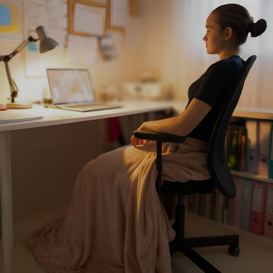 Snhug Sit sitting blanket worn around the waist with no sleeves, keeping arms free while seated.